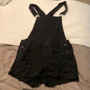 Black, ripped denim overalls